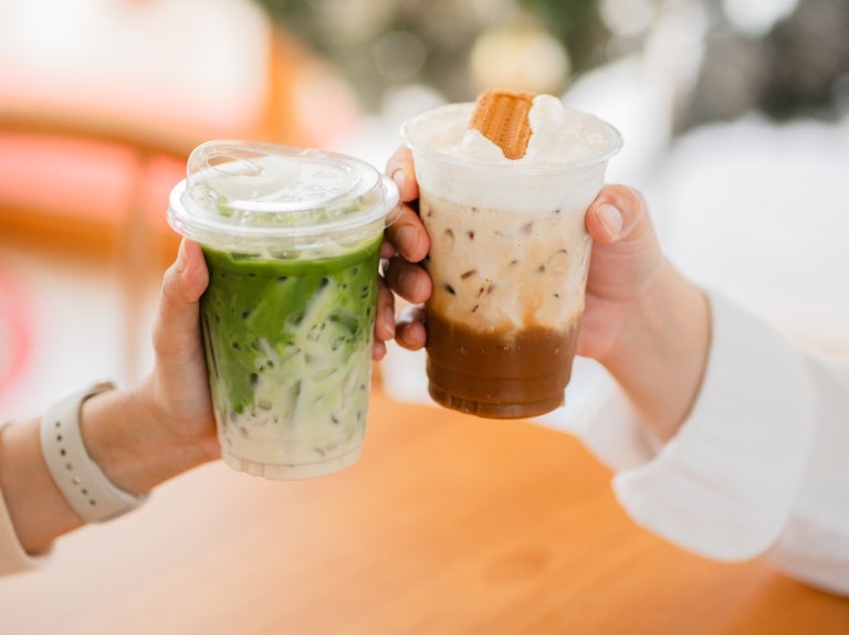 Two cupped sweet iced cold drinks