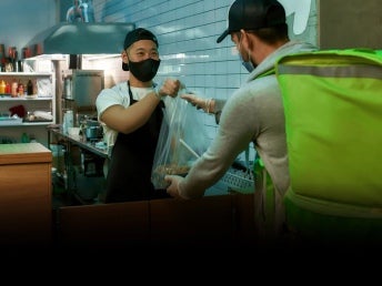 Delivery man getting food at the restaurant.