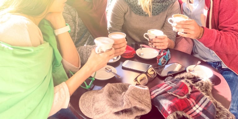 Group of best friends drinking coffee at bar cafe